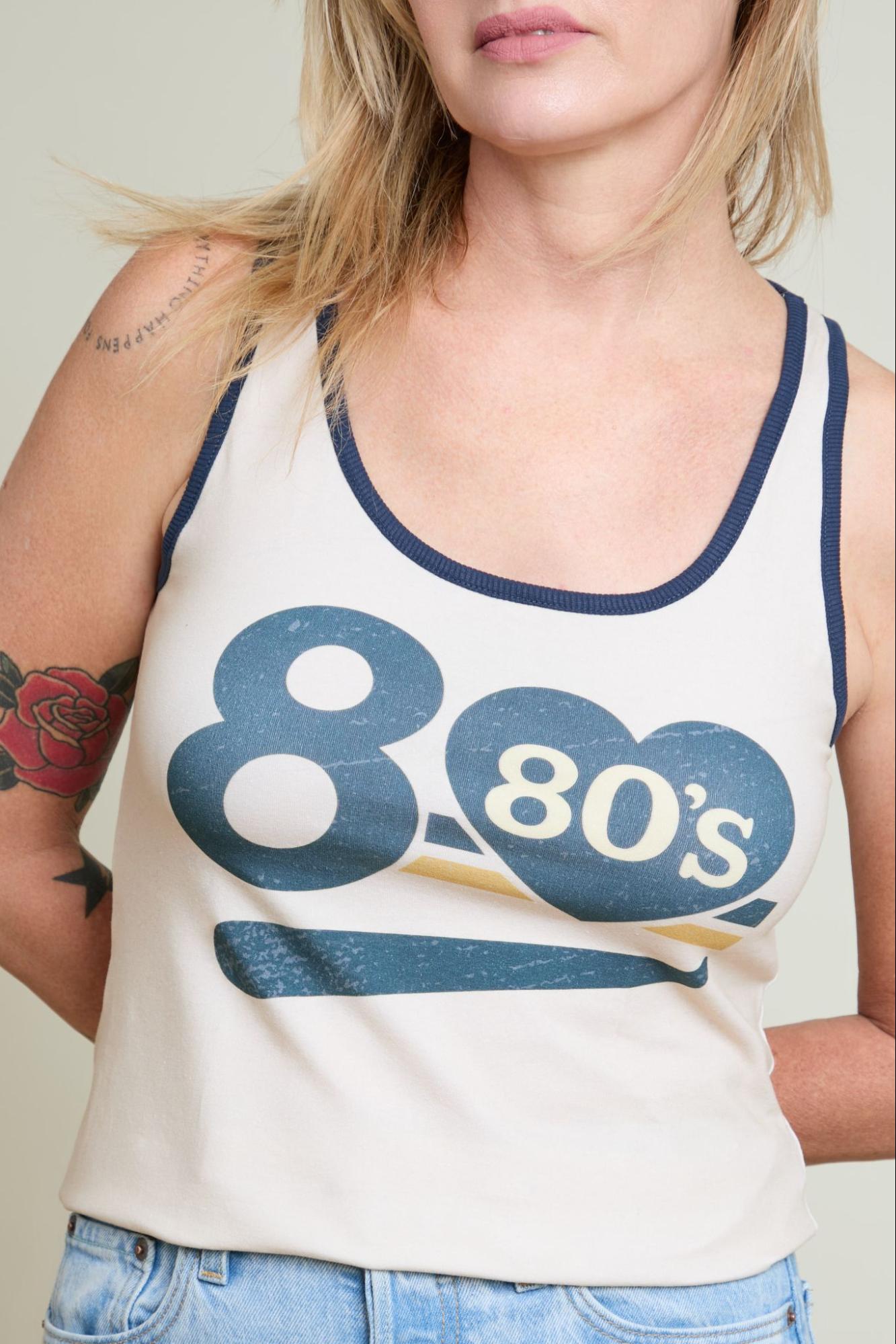 Person wearing a tank top with '80s' design