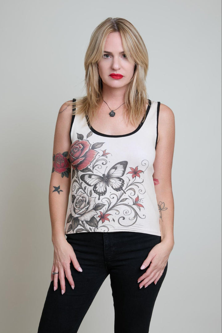 Woman wearing a sleeveless top with floral and butterfly design on a plain background