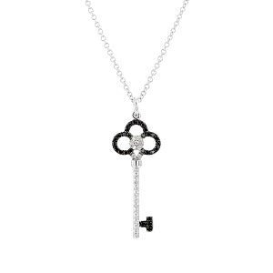 Silver necklace with a key-shaped pendant featuring black and white stones on a white background