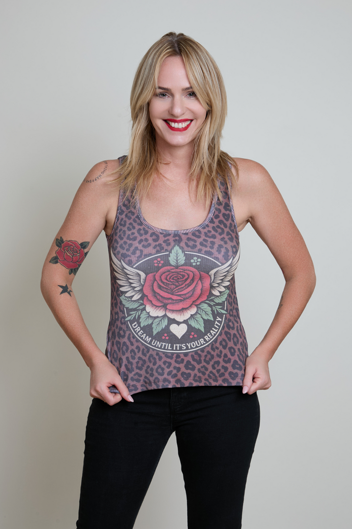 Woman wearing a tank top with a rose design on a plain background