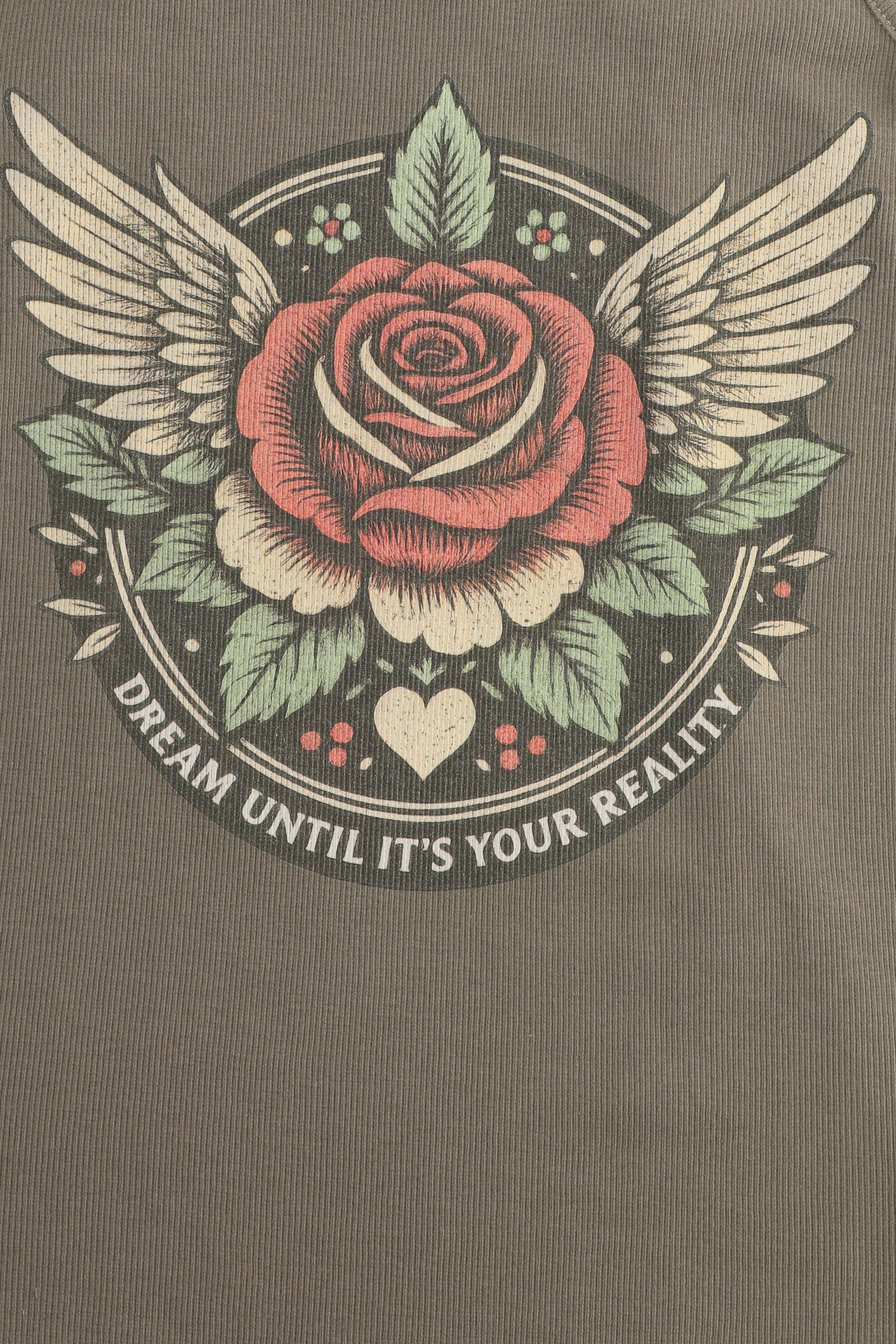 Rose with wings and leaves on a brown background with text 'Dream until it's your reality'.