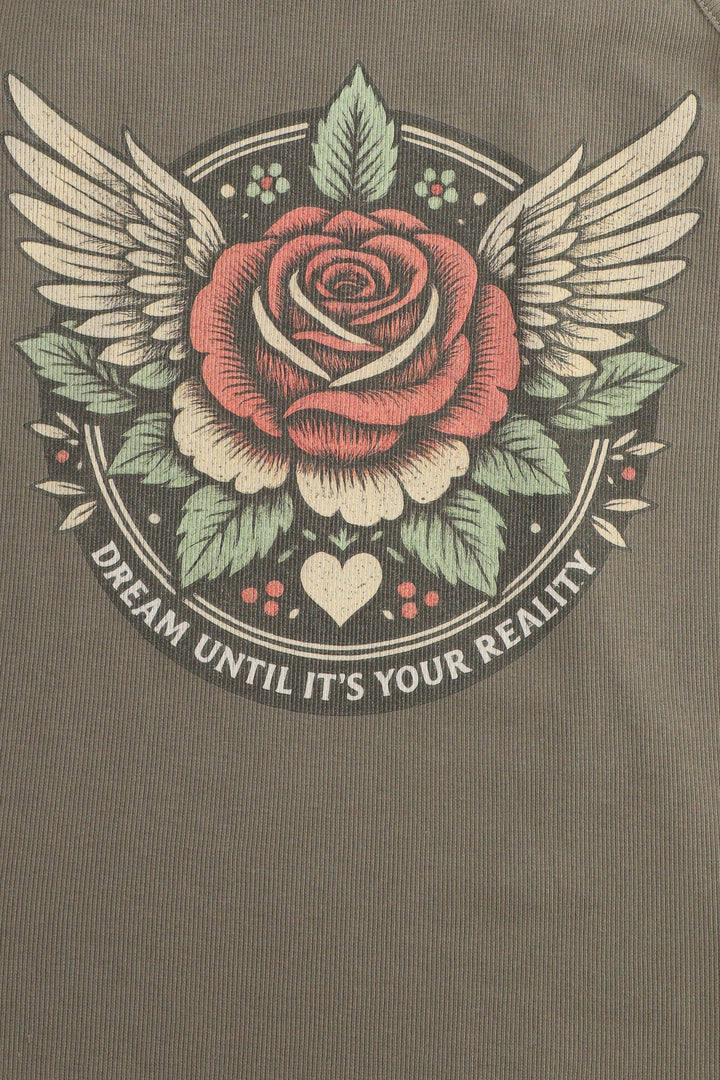 Rose with wings and leaves on a brown background with text 'Dream until it's your reality'.