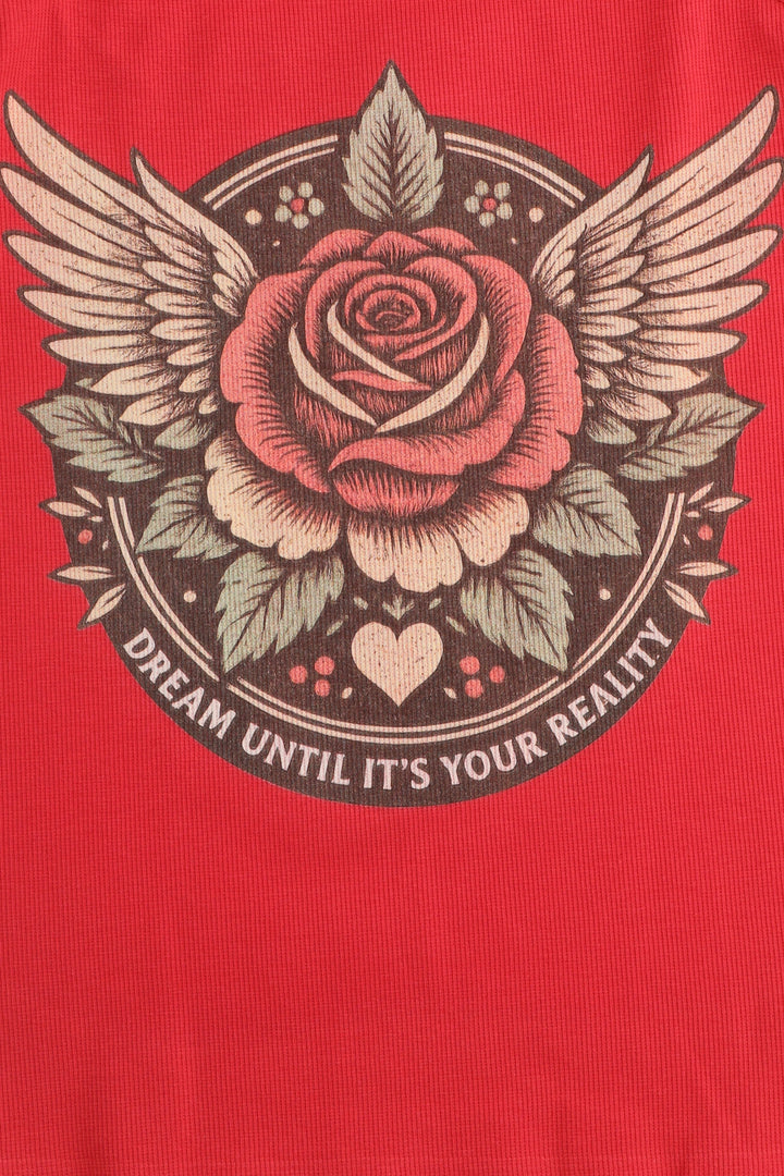 Red t-shirt with a rose design and text 'Dream until it's your reality' on a red background