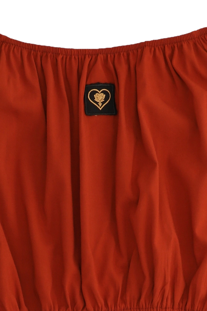 Red fabric with a heart-shaped logo patch on a white background