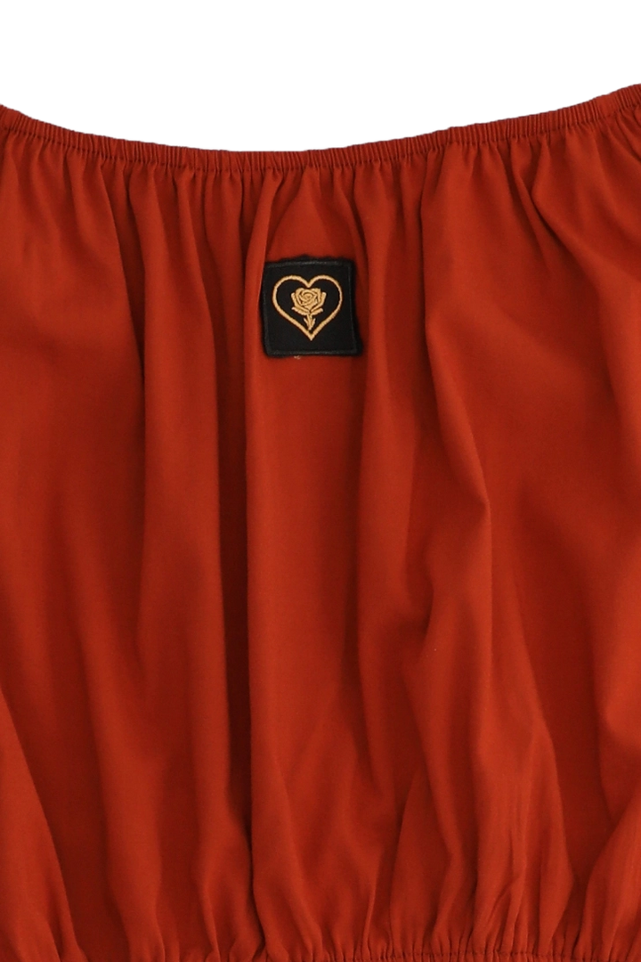 Red fabric with a heart-shaped logo patch on a white background