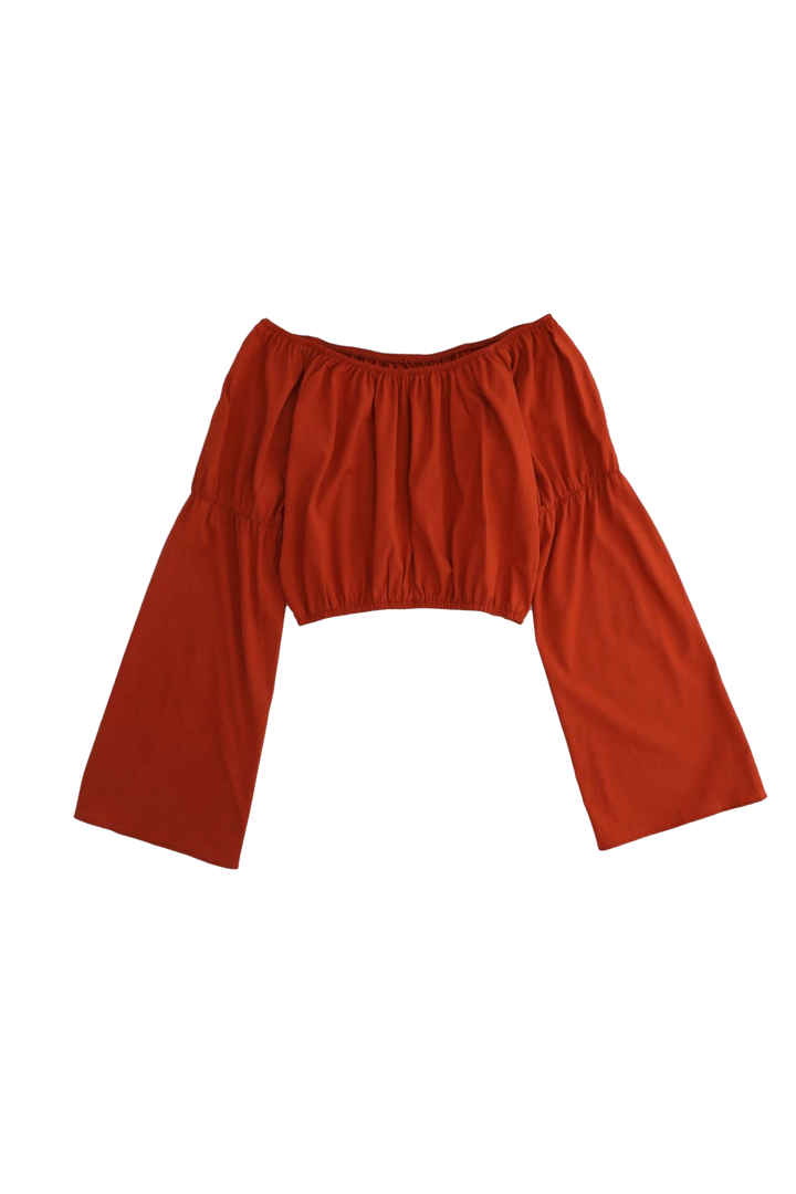 Red off-shoulder top with wide sleeves on a white background