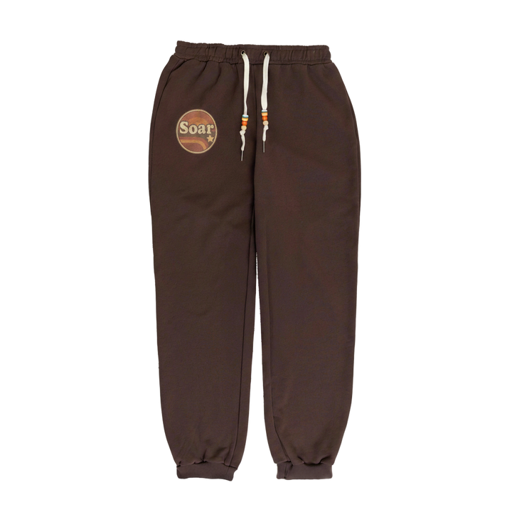 Brown sweatpants with a logo on the left leg against a white background
