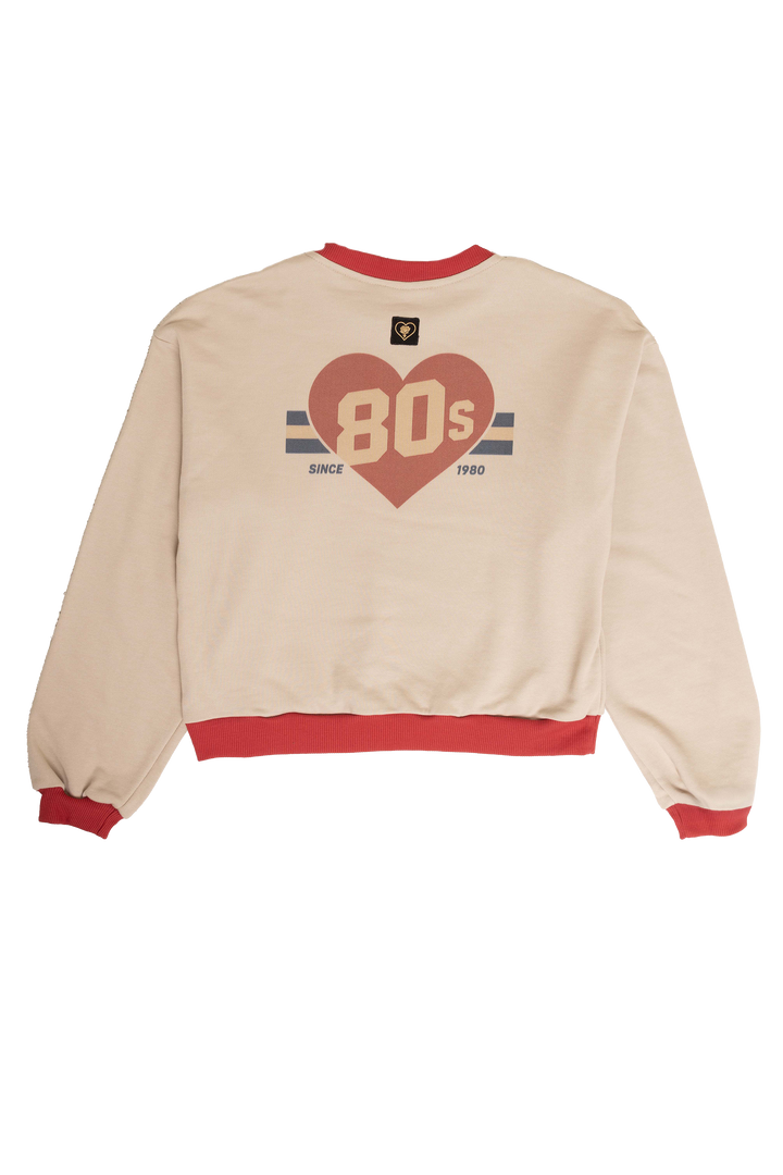 Beige sweatshirt with red heart and text design on a white background
