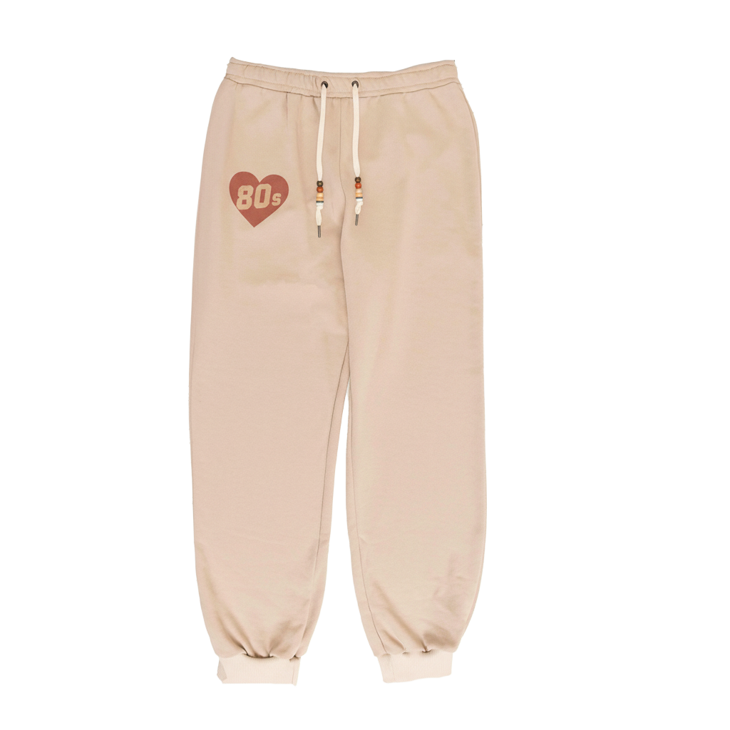 Beige sweatpants with a heart and '80s' design on a white background