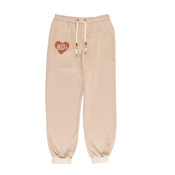 Beige sweatpants with a heart and '80s' design on a white background