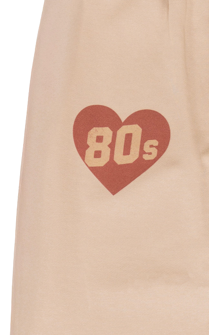 Heart-shaped design with '80s' text on a beige background