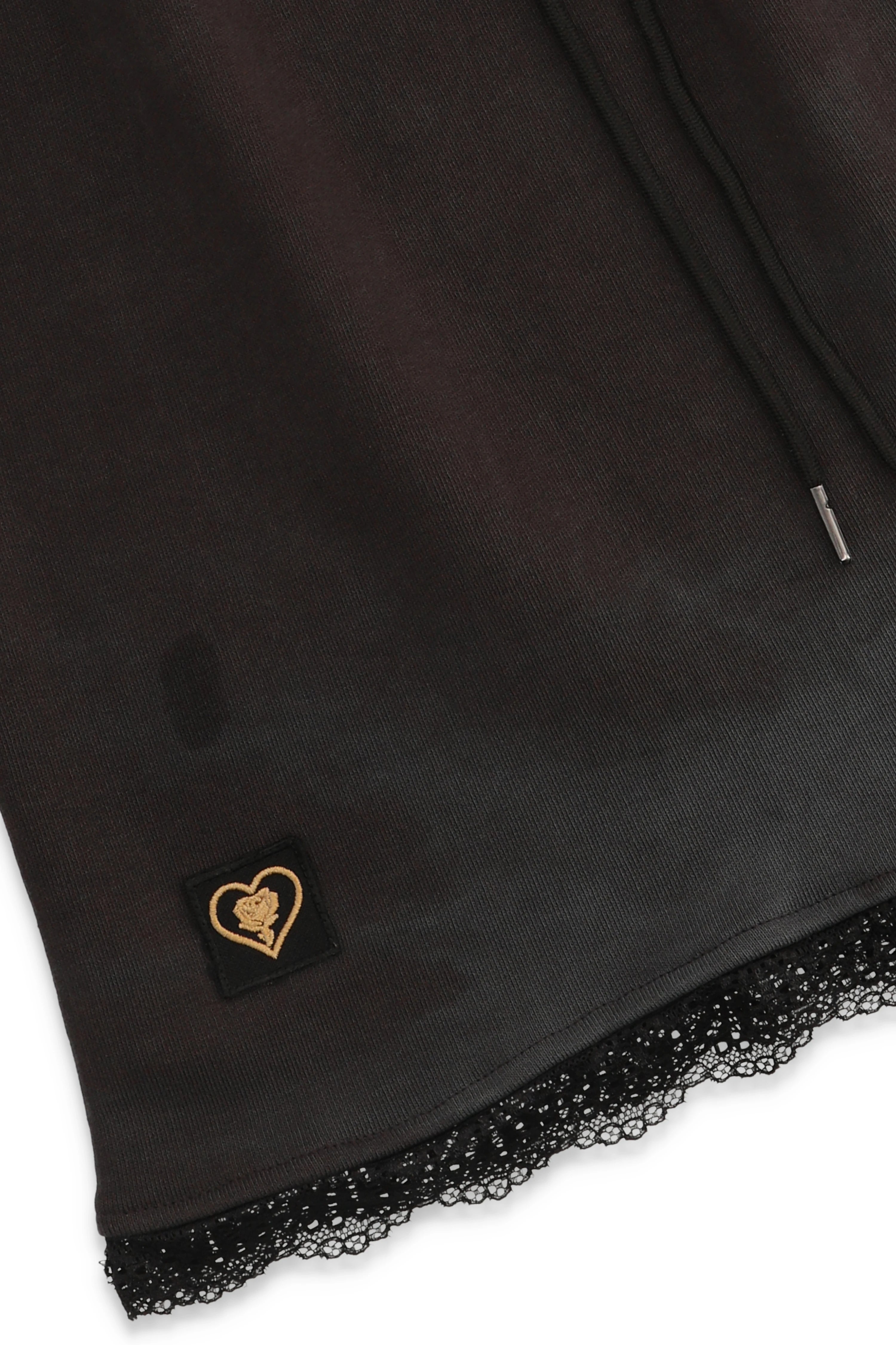 Black fabric with a heart-shaped logo tag on a white background
