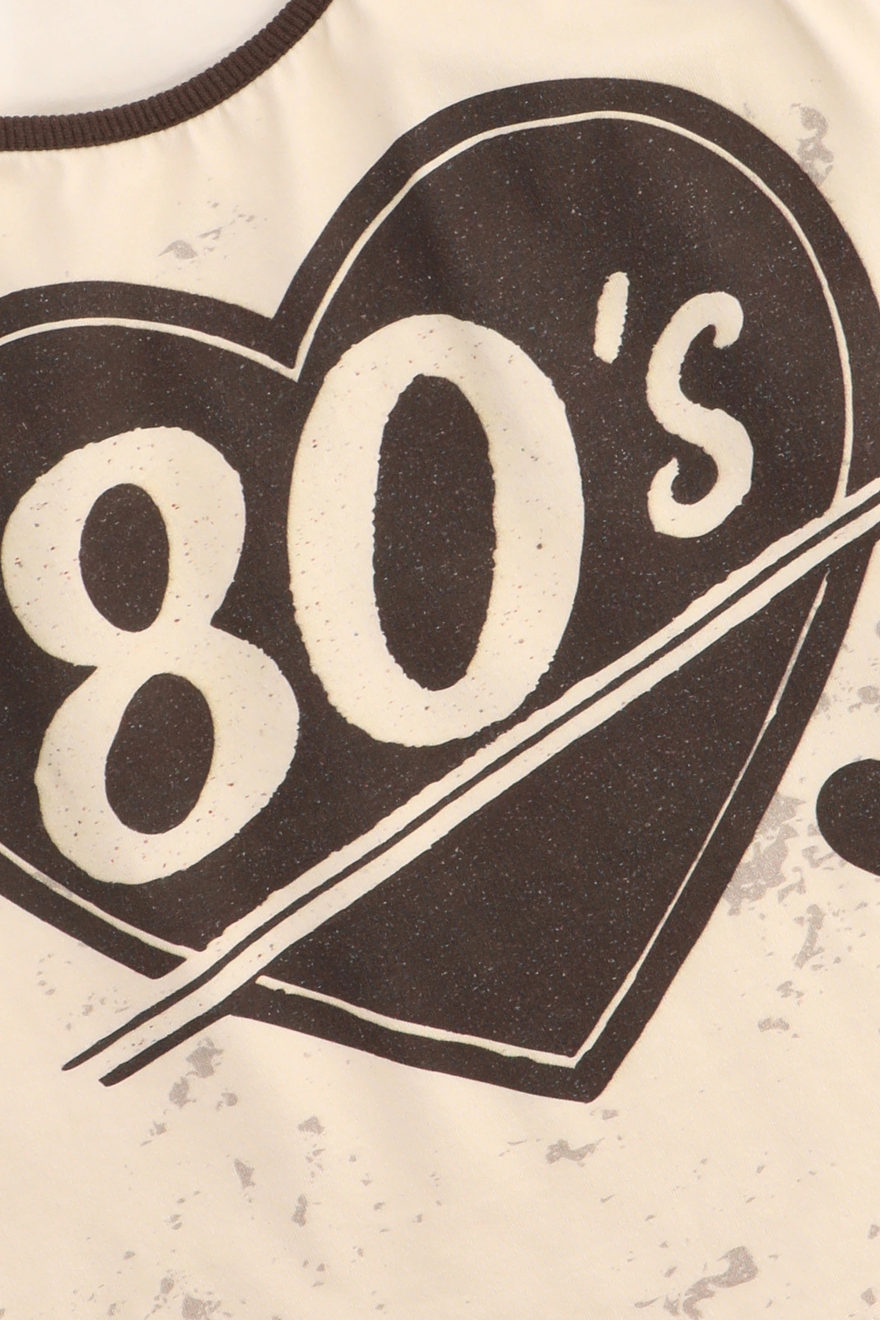 Heart-shaped design with '80's' text on a textured background