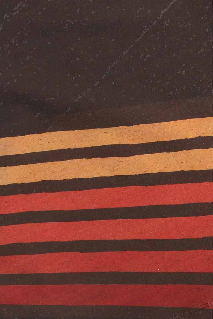 Close-up of fabric with horizontal stripes in brown, black, and red on a dark background.