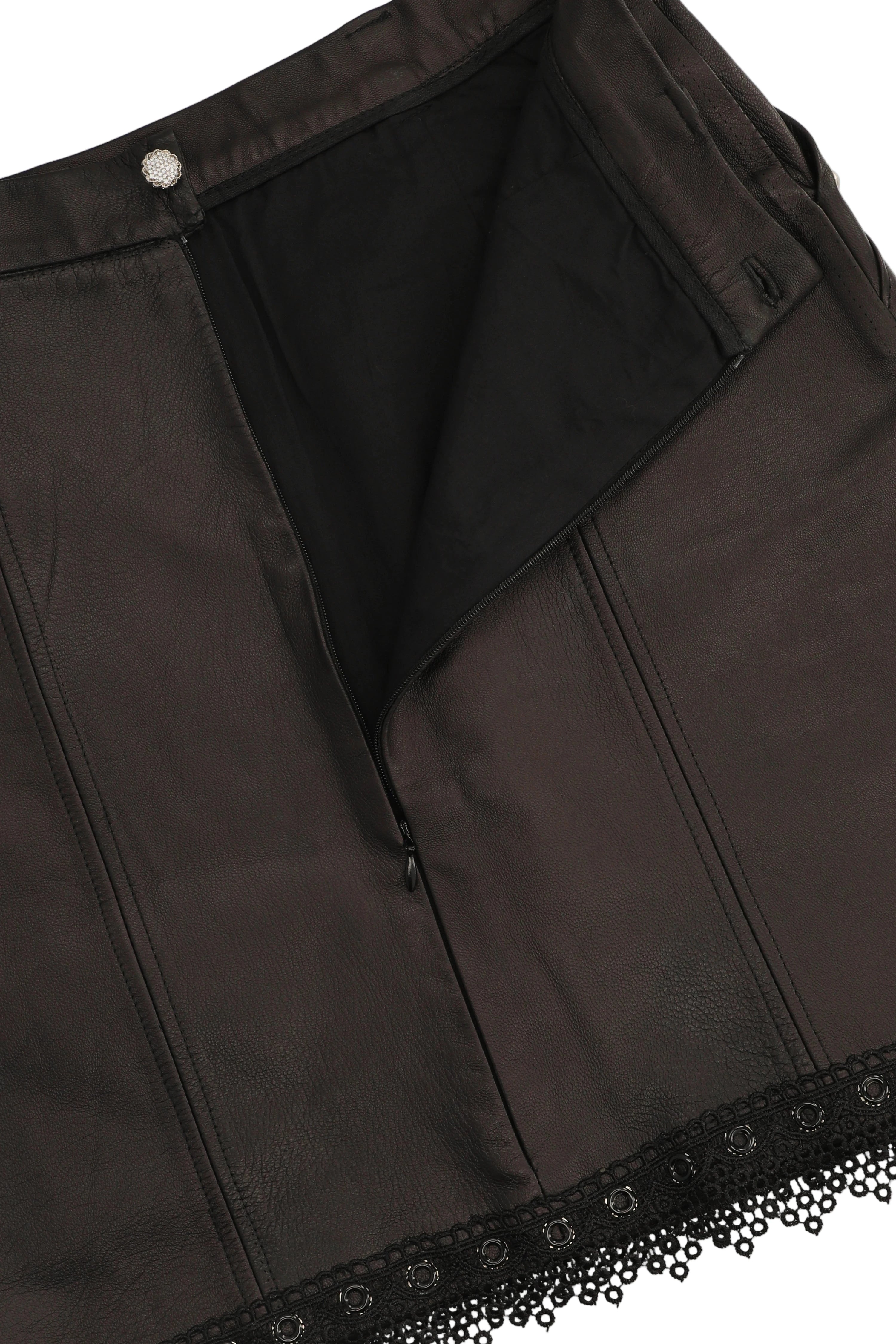 Close-up of a black garment with lace trim on a white background