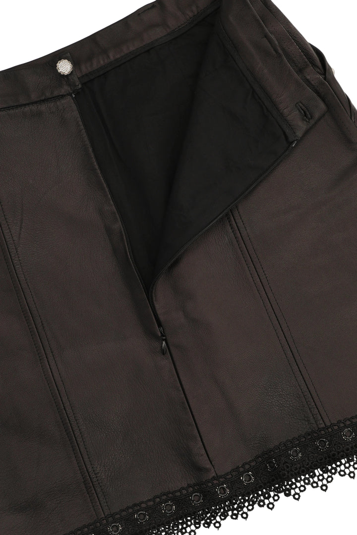 Close-up of a black garment with lace trim on a white background