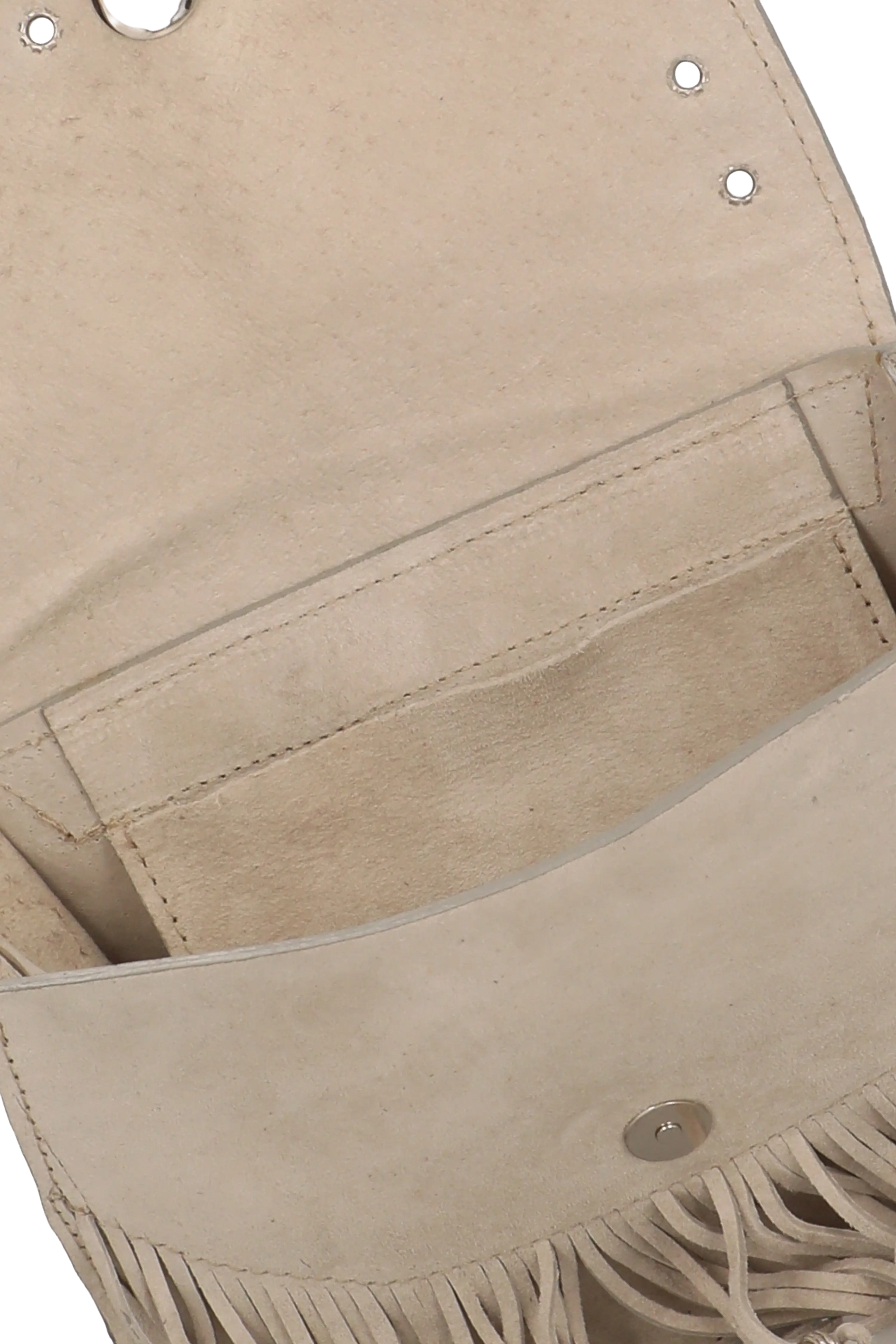 Close-up of a beige leather bag with fringe details on a white background