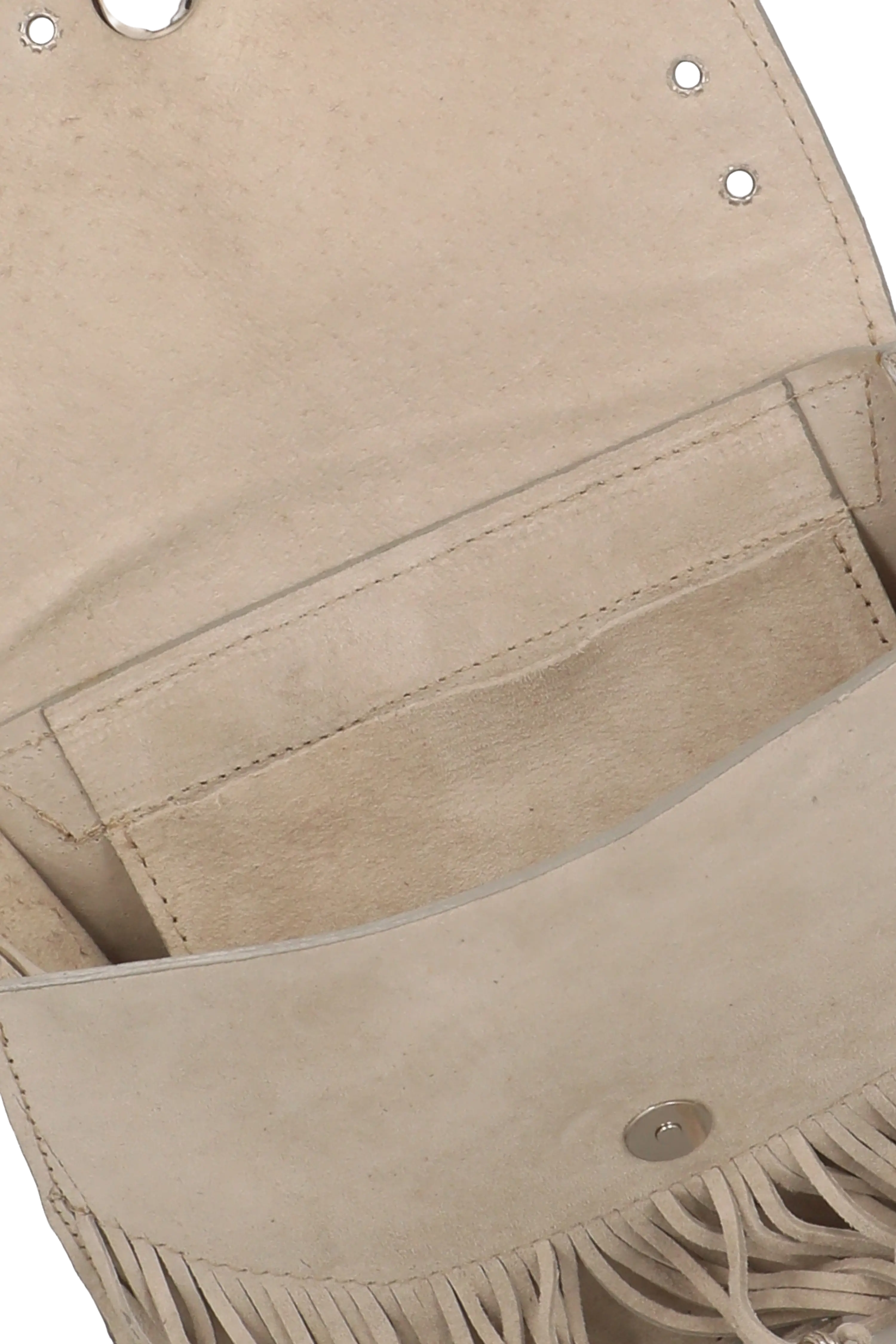 Close-up of a beige leather bag with fringe details on a white background