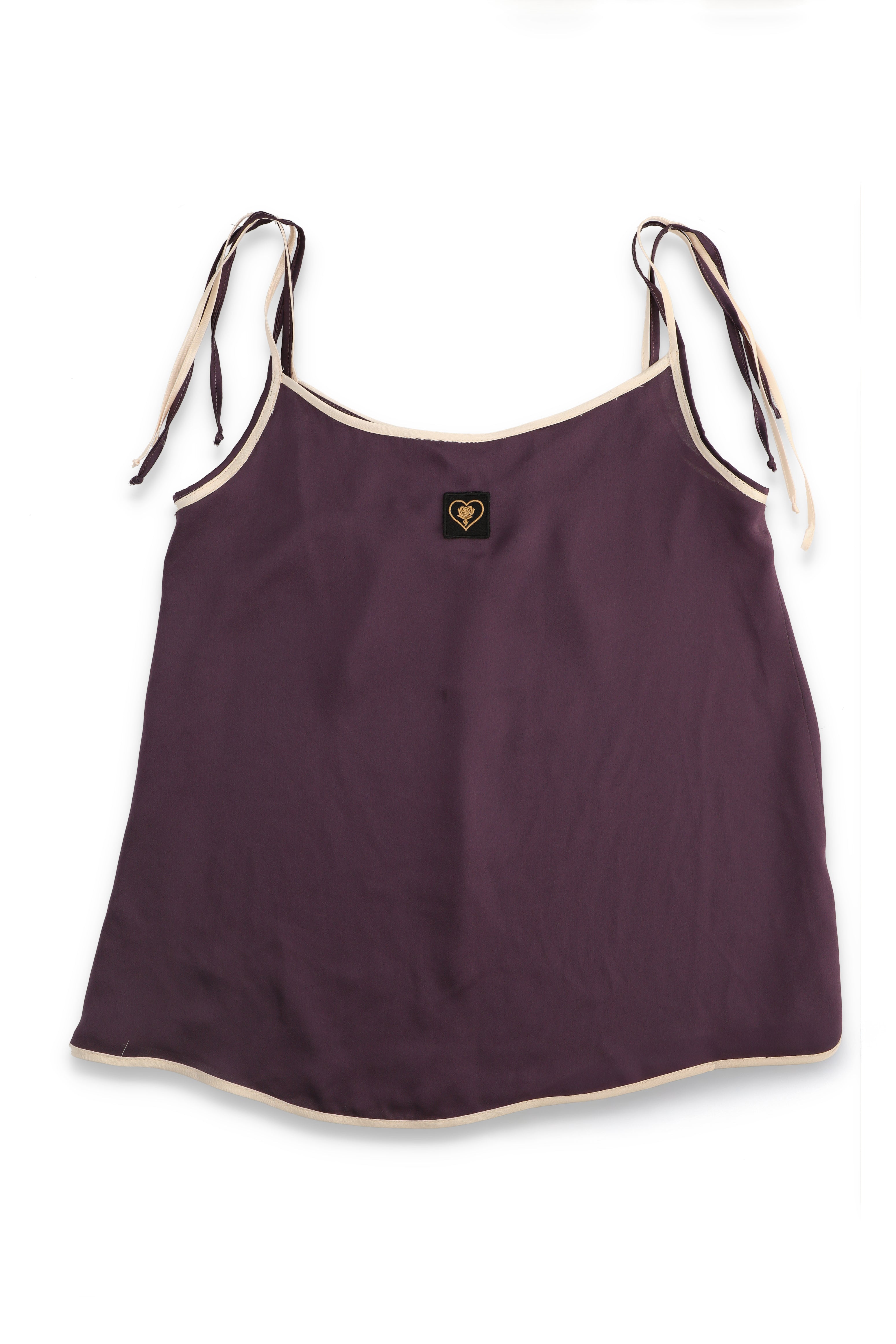 Purple tank top with white straps on a white background