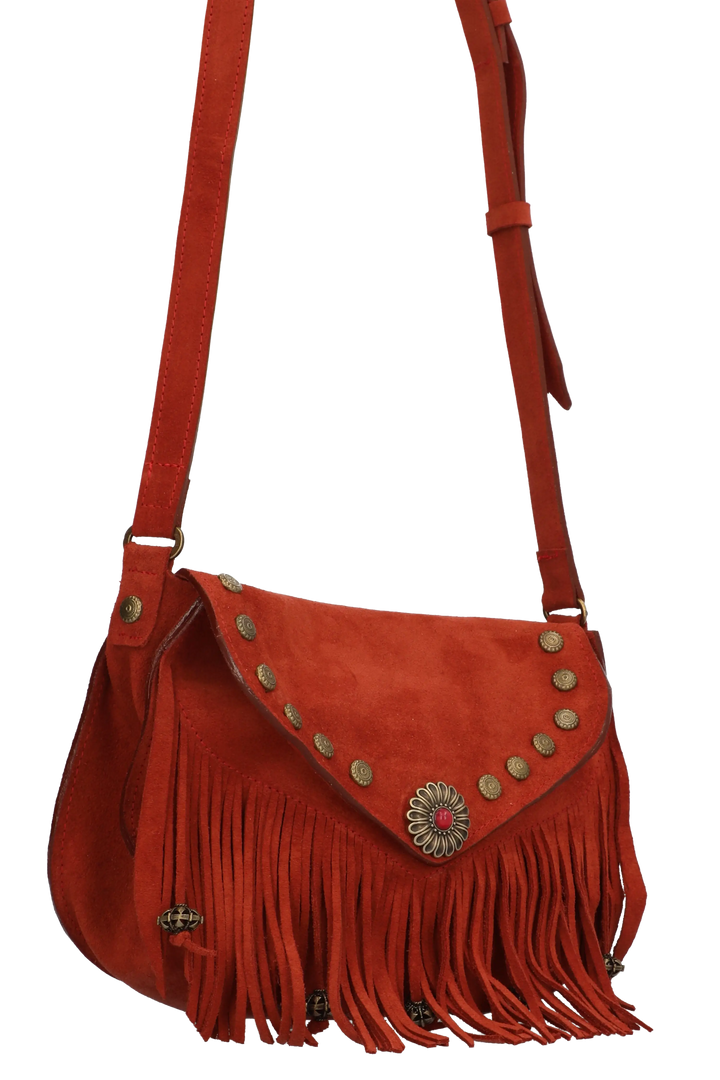 Red suede handbag with fringe and decorative stud details on a white background