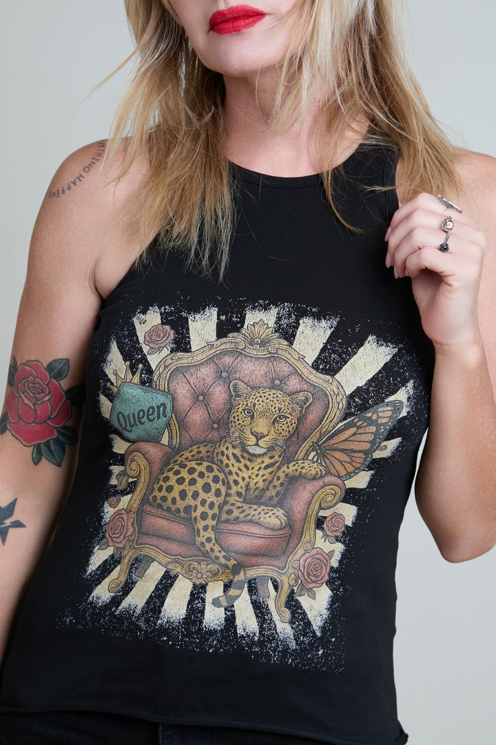 Person wearing a black tank top with a leopard design on a white background