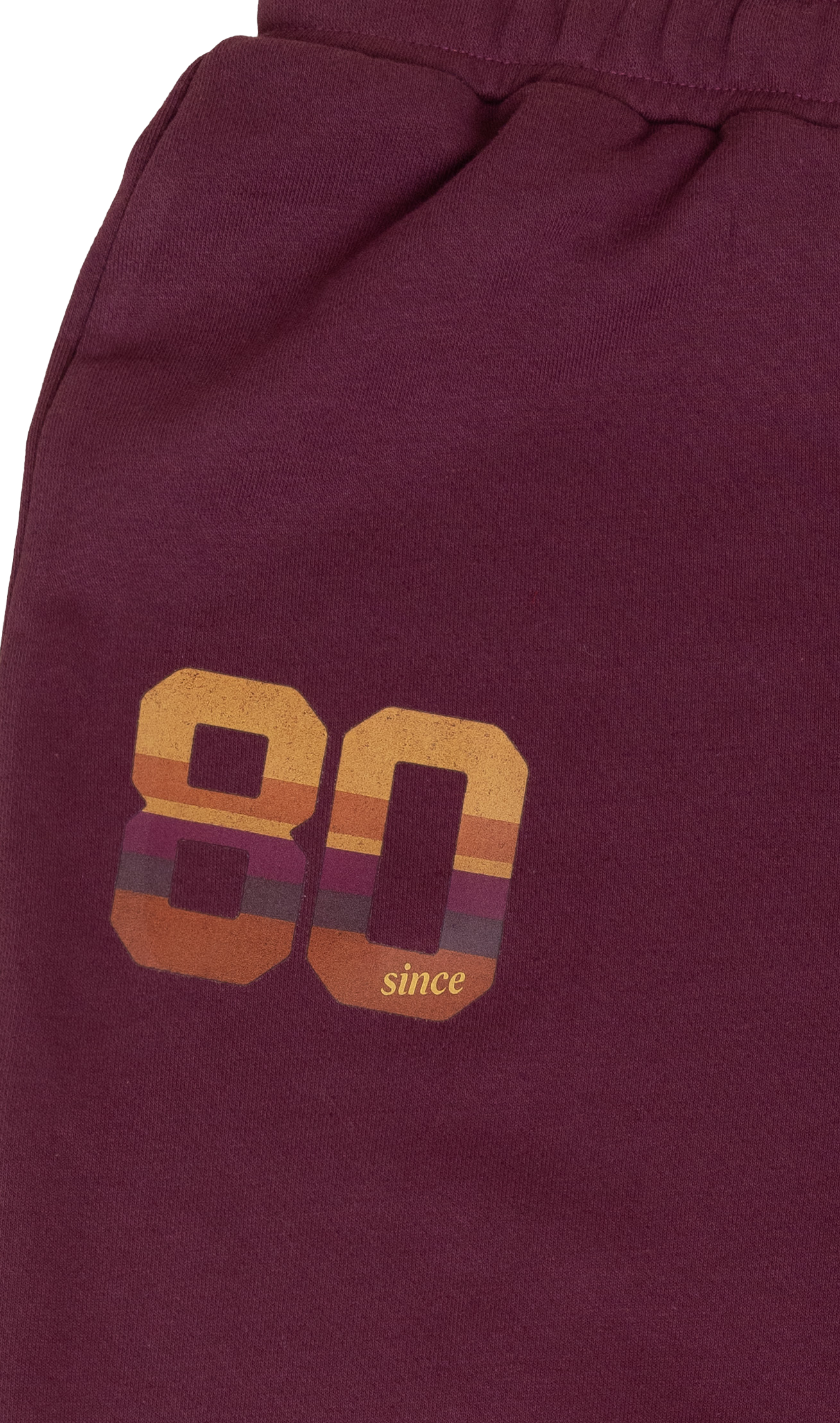 Maroon shorts with '80 since' text and design on a maroon background