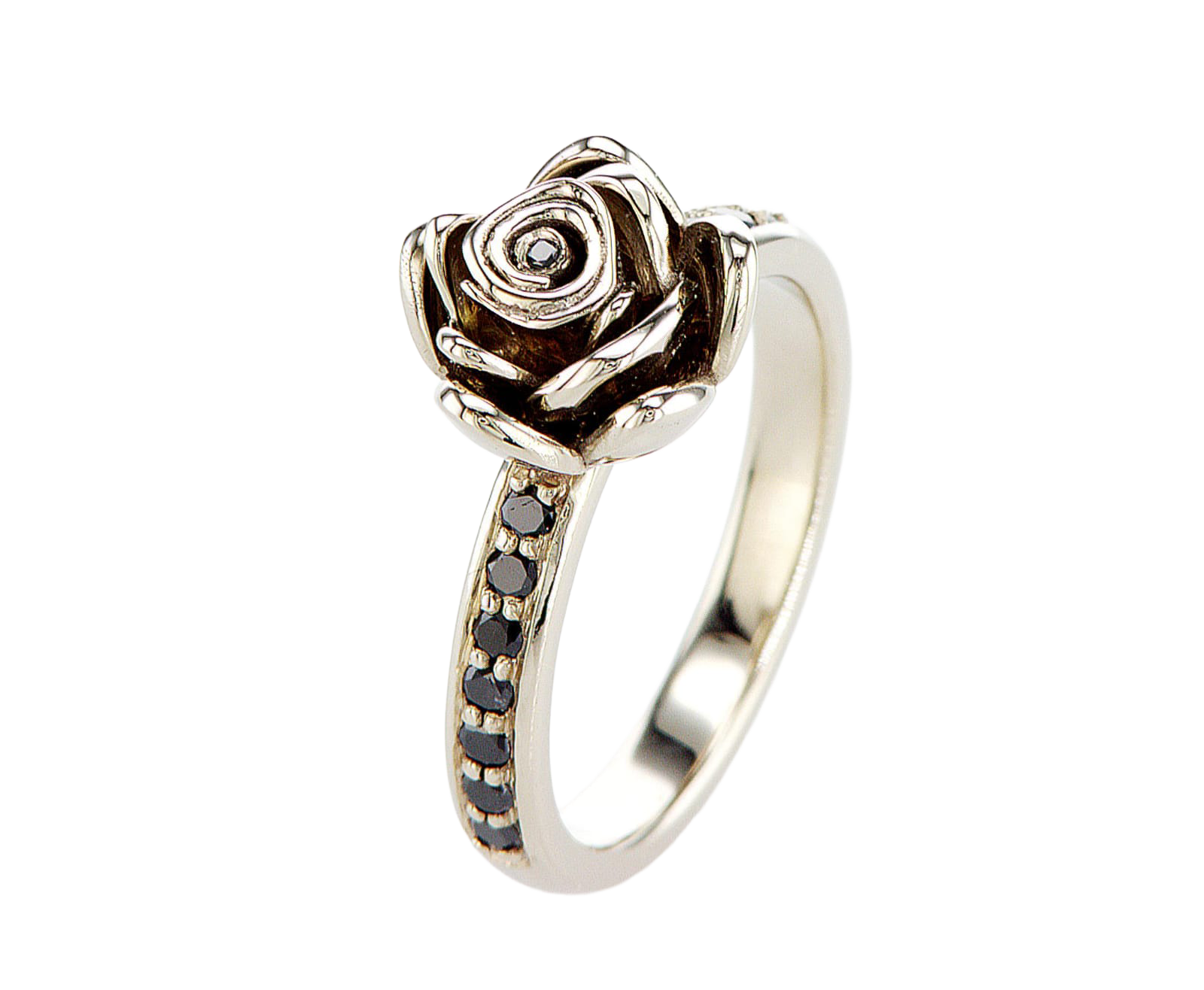 Silver ring with rose design and black gemstones on a white background