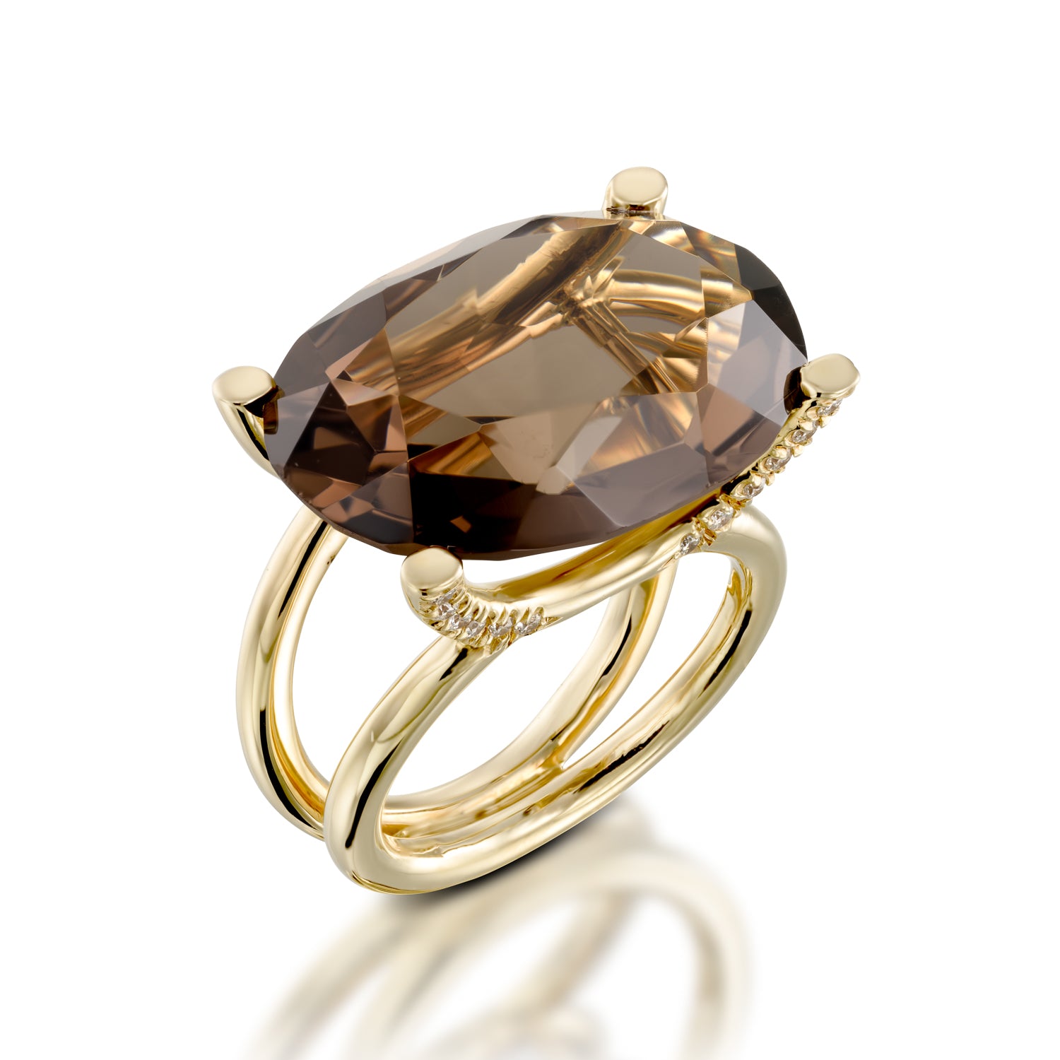 Gold ring with a large brown gemstone on a white background