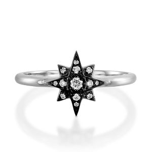 Star-shaped ring with black and clear gemstones on a white background