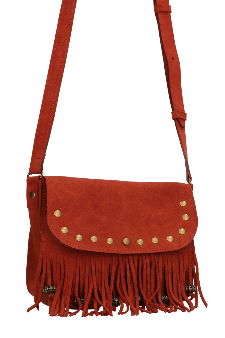 Red suede handbag with fringe and gold studs on a white background
