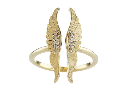 Gold wing-shaped bracelet with embedded stones on a white background