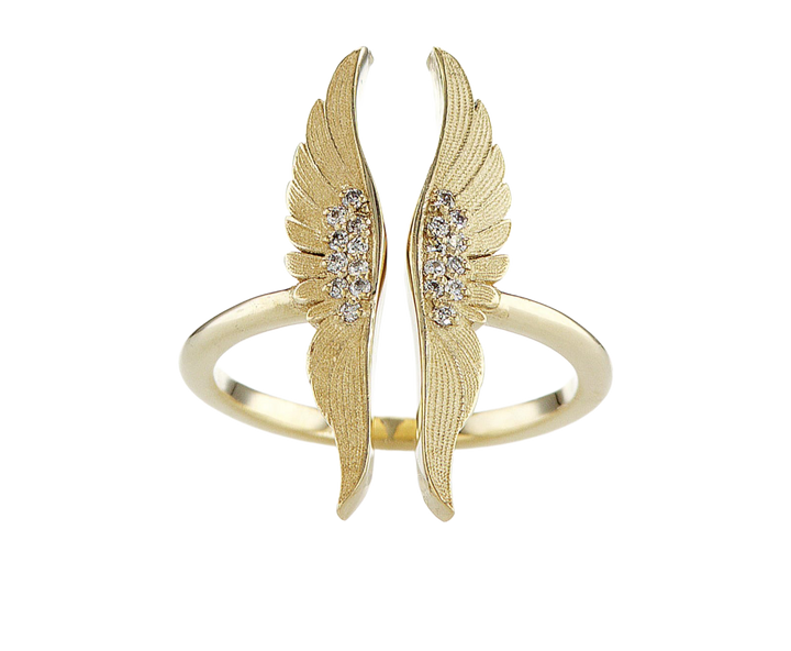Gold wing-shaped bracelet with embedded stones on a white background