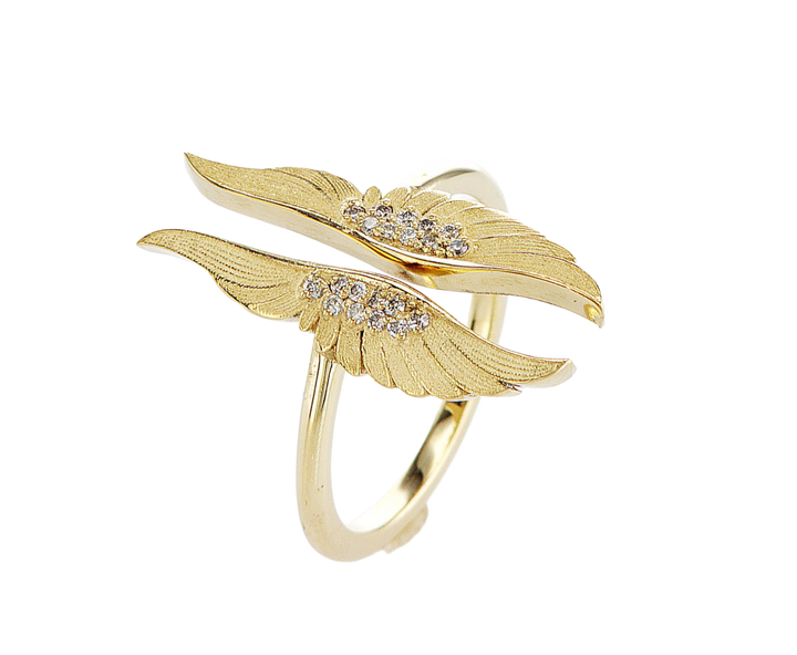 Gold wing-shaped ring with diamond accents on a white background