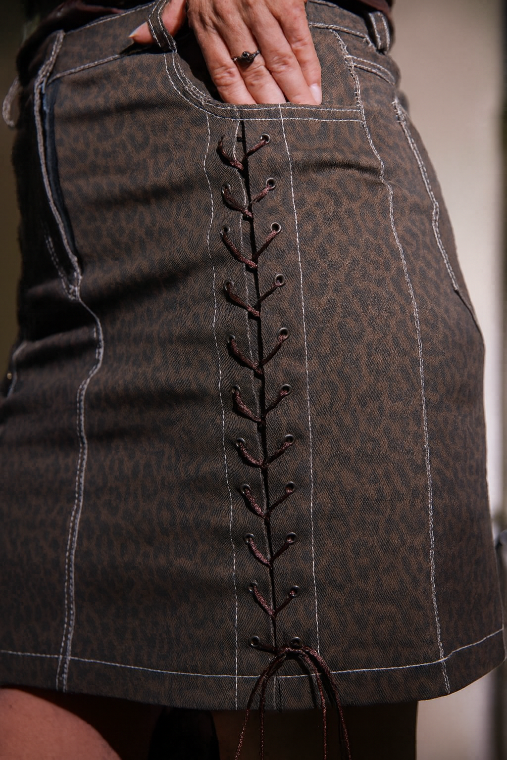 Brown patterned skirt with decorative stitching detail