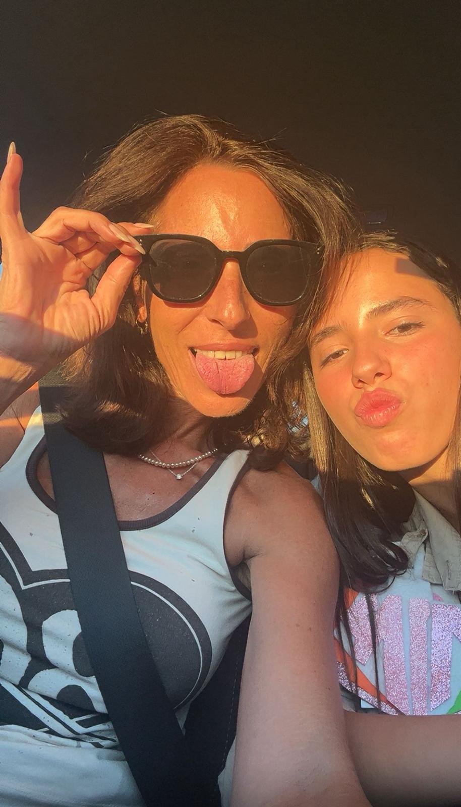 Two women posing for a selfie with sunglasses on, outdoors.