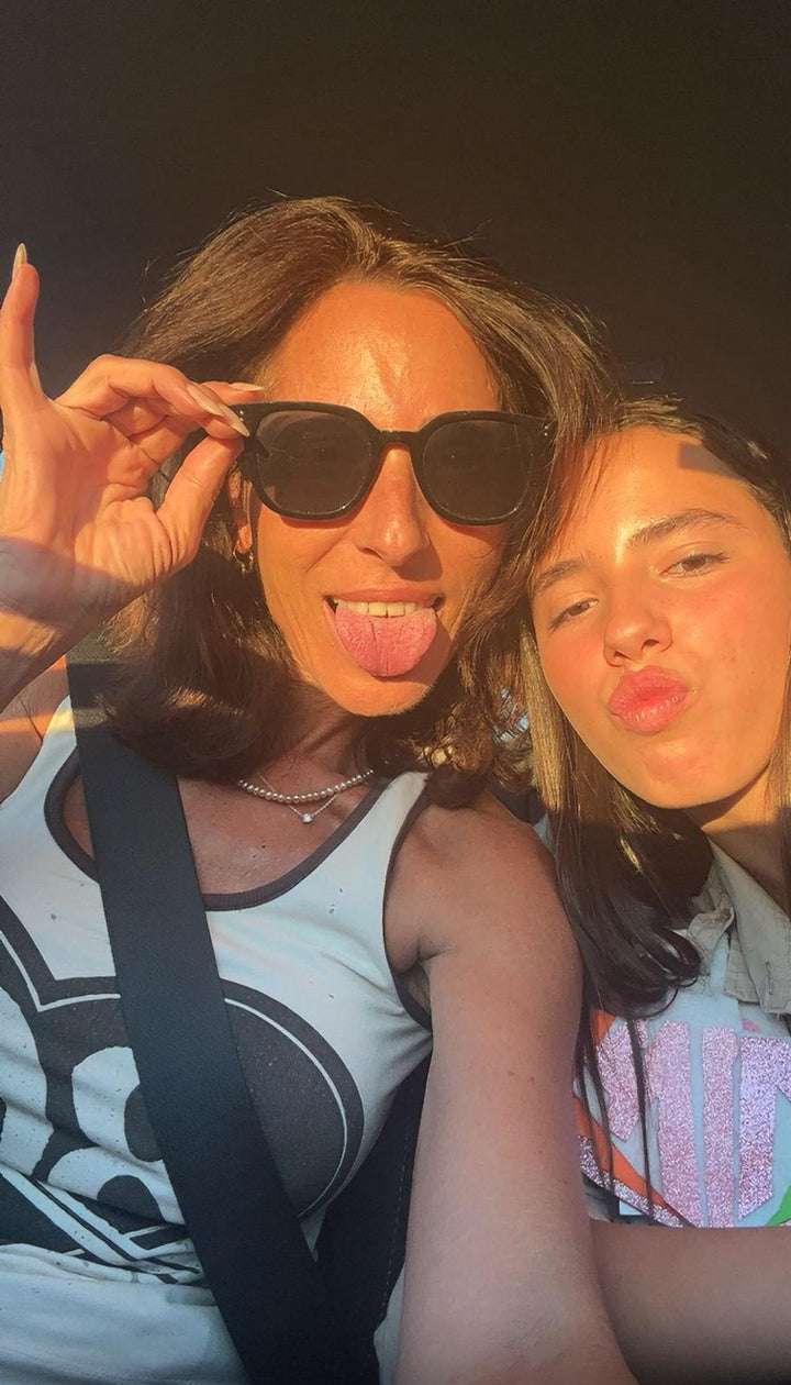 Two women posing for a selfie with sunglasses on, outdoors.